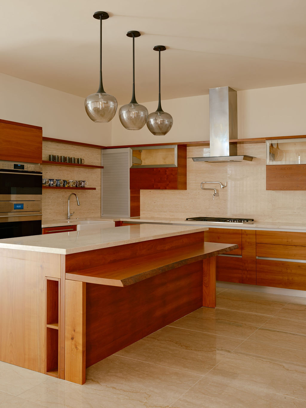 Modern kitchen with custom pendant light fixtures and wood cabinetry